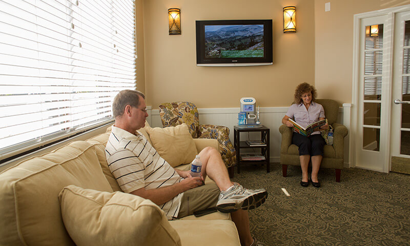 Two dental patients in comfortable waiting area
