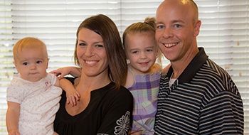 Smiling family of four in reception area