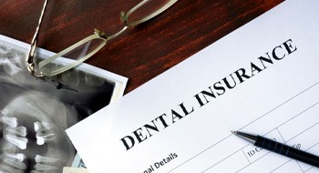 A dental insurance form marking the cost of a root canal in Daytona Beach