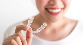 Patient holding Invisalign in Daytona Beach