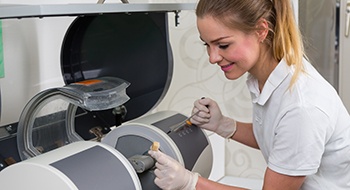 Dental team member using CEREC milling unit