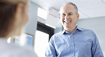 Man smiling at reception desk