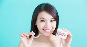Woman comparing ClearCorrect and traditional braces