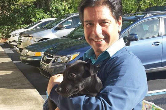 Dr. Lloyd holding a puppy