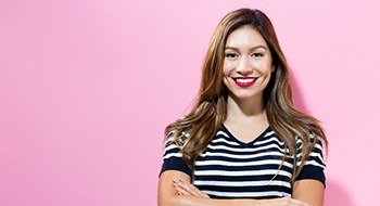 woman smiling after visiting a cosmetic dentist in Daytona Beach