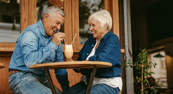 Senior couple with dentures in Daytona Beach sharing a milkshake