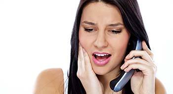 Pained woman calling her Daytona Beach emergency dentist