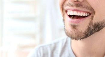 Close up of man’s nice smile with grey t shirt