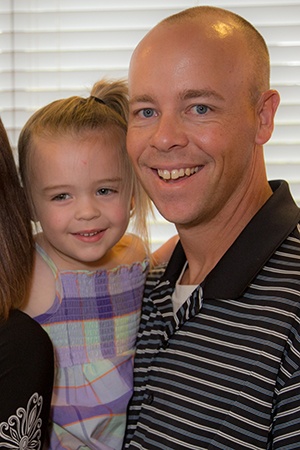 Father and daughter smiling in waiting room