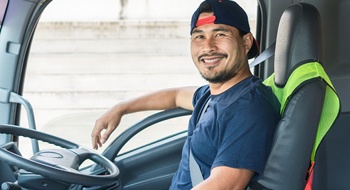 worker smiling while sitting in a truck after gum recontouring in Daytona Beach