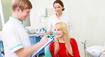 Woman talking to dentist about insurance