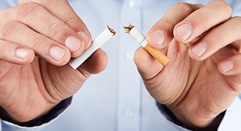 A person breaking a cigarette in half in Daytona Beach