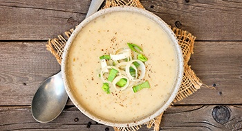 A bowl of warm soup with a spoon in Daytona Beach