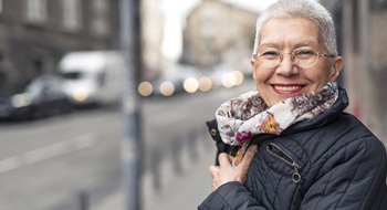 An older woman with dental implants in Daytona Beach.