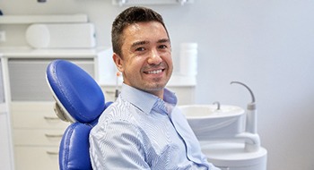 smiling man sitting in the dental treatment chair
