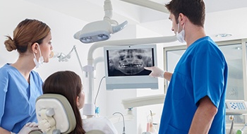 dentist showing a patient their dental X-rays 