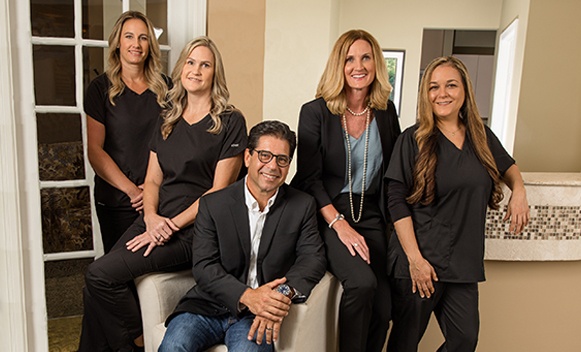 Smiling Daytona Beach dentist and dental team members