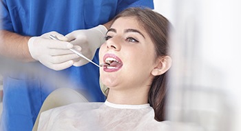 Woman receiving oral cancer screening