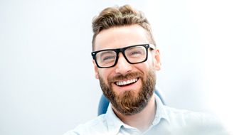 Man with an attractive smile in dental chair