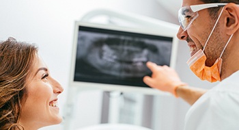 Dentist and patient looking at x-rays