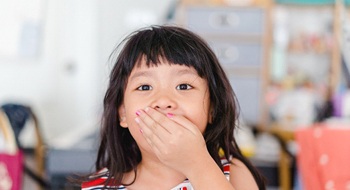 a child covering their mouth