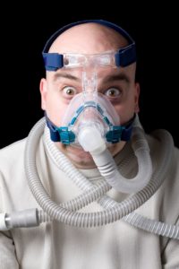 scared man wearing sedation mask 