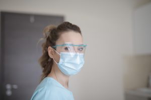 Dental hygienist at dentist in Daytona Beach wearing a mask.