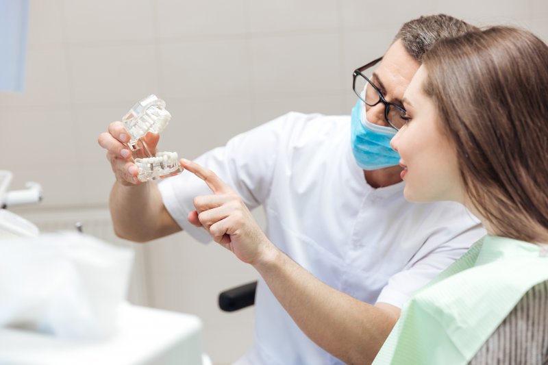 dentist discusses dental implants with diabetic patient