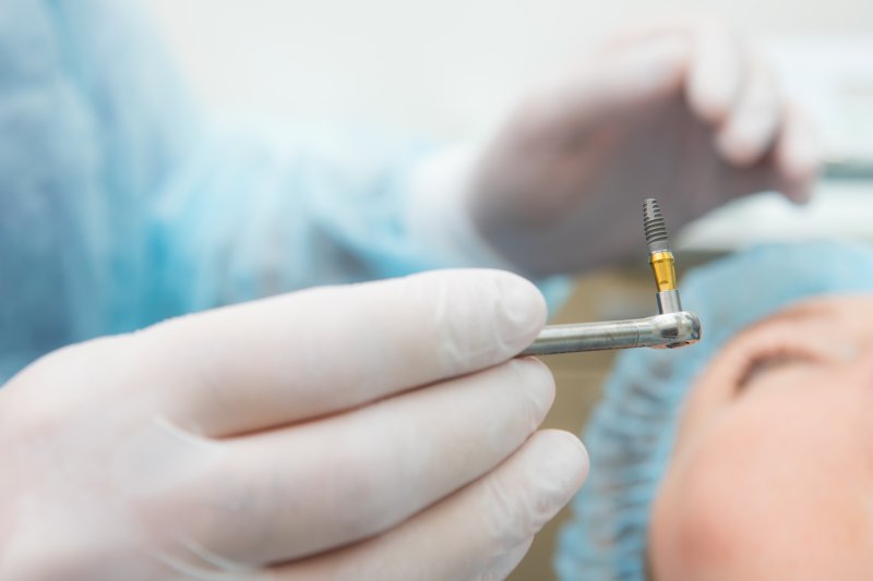 dentist placing a dental implant