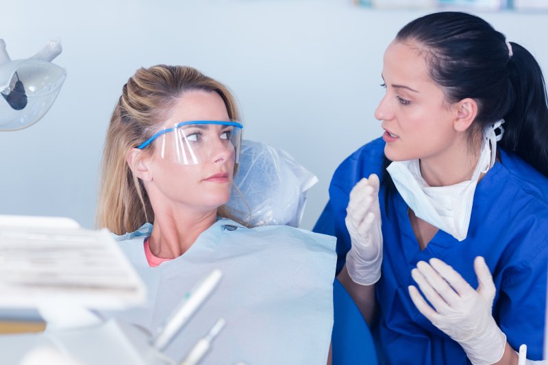 patient at speaking to dentist about receiving root canal therapy