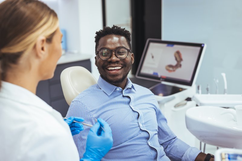 Patient smiling at their dental implant consultation