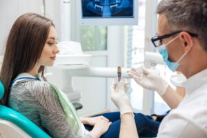 Woman listening to her dentist at dental implant consultation