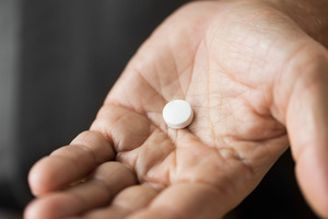 Close-up of pill in palm of hand